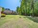 Expansive green backyard featuring mature trees and a shed, perfect for outdoor activities at 936 Elbridge Dr, Raleigh, NC 27603