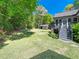 Beautiful backyard with mature trees, a deck, and green grass at 936 Elbridge Dr, Raleigh, NC 27603