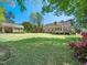 The backyard boasts beautiful green lawn, a storage shed, and colorful flower bushes at 936 Elbridge Dr, Raleigh, NC 27603