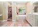 Open bathroom featuring a soaking tub, stand up shower, vanity and patterned tile floor at 936 Elbridge Dr, Raleigh, NC 27603