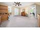 Spacious bedroom with tan carpet, a window seat, a closet and an archway to another room at 936 Elbridge Dr, Raleigh, NC 27603