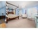 Bedroom featuring a canopy bed, a couch, a chandelier, and light blue walls at 936 Elbridge Dr, Raleigh, NC 27603