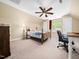 Cozy bedroom features a ceiling fan, large window, and plenty of natural light at 936 Elbridge Dr, Raleigh, NC 27603