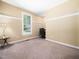 Neutral-colored bedroom with large window allowing natural light, and carpeted flooring at 936 Elbridge Dr, Raleigh, NC 27603