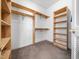 Walk-in closet with built-in wooden shelving, ready to accommodate any wardrobe at 936 Elbridge Dr, Raleigh, NC 27603