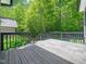 Wooden deck overlooks the lush green landscape surrounding the home at 936 Elbridge Dr, Raleigh, NC 27603