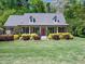 Charming brick home featuring a cozy front porch, dormer windows and a red front door at 936 Elbridge Dr, Raleigh, NC 27603