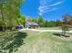 Charming home with a well-manicured lawn, complemented by mature trees and a detached two-car garage at 936 Elbridge Dr, Raleigh, NC 27603