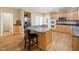 Open kitchen with granite countertops, stainless steel appliances, and breakfast bar at 936 Elbridge Dr, Raleigh, NC 27603