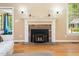 Living room featuring a brick fireplace, mantle and wood floors at 936 Elbridge Dr, Raleigh, NC 27603