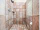 Tiled stand up shower with shower head, soap holder and glass block window for natural light at 936 Elbridge Dr, Raleigh, NC 27603