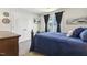 Comfortable bedroom with blue bedding, a small TV, and a window offering natural light at 98 Buddy Campbell Ct, Angier, NC 27501