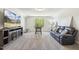 Spacious bonus room with a comfortable leather sofa and a flat-screen TV for entertainment at 98 Buddy Campbell Ct, Angier, NC 27501