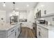 Bright kitchen features a large island with seating and stainless-steel appliances at 98 Buddy Campbell Ct, Angier, NC 27501