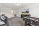 Spacious living room features gray carpet, a television, and a foosball table for entertainment at 98 Buddy Campbell Ct, Angier, NC 27501