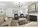 Open-concept living room with fireplace, plush seating, and plenty of natural light at 98 Buddy Campbell Ct, Angier, NC 27501