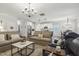 Spacious living area leading to a modern kitchen with white cabinets and stainless appliances at 98 Buddy Campbell Ct, Angier, NC 27501