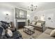 Cozy living room features a fireplace, elegant chandelier, and comfortable seating at 98 Buddy Campbell Ct, Angier, NC 27501