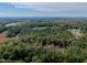Scenic aerial view of a wooded lot with lush trees, offering a private and serene setting at 000 Olivia Pope Way, Efland, NC 27243