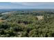 Aerial view of a tree covered property including a residence with a neighboring grassy park at 000 Olivia Pope Way, Efland, NC 27243