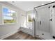 Bright bathroom features a glass enclosed shower, tub, two windows and wood-look floor at 000 Olivia Pope Way, Efland, NC 27243