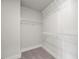 Walk-in closet offers multiple metal shelves and neutral carpet in a well lit area at 000 Olivia Pope Way, Efland, NC 27243
