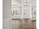 Light and airy foyer features pristine white walls, hardwood floors, and a charming entry door at 000 Olivia Pope Way, Efland, NC 27243