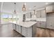 Modern kitchen featuring a large island, gray cabinetry, and stainless steel appliances at 000 Olivia Pope Way, Efland, NC 27243