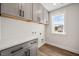 The laundry room includes overhead storage, a window view, and hookups for appliances at 000 Olivia Pope Way, Efland, NC 27243