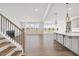 Open-concept living room with wood floors, fireplace, and views of the backyard at 000 Olivia Pope Way, Efland, NC 27243