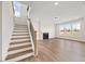 Bright living room features stairs, hardwood floors, a fireplace, and many windows for natural light at 000 Olivia Pope Way, Efland, NC 27243