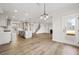 Open-concept living room features kitchen, stairs, and fireplace at 000 Olivia Pope Way, Efland, NC 27243