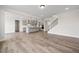 Spacious living room shows open floorplan with hardwood floors, stairs, kitchen, and plenty of natural light at 000 Olivia Pope Way, Efland, NC 27243