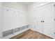 Well-organized mudroom features a bench with storage cubbies, hooks, and a closet at 000 Olivia Pope Way, Efland, NC 27243