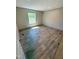 Bedroom showcasing natural light from the window and wood-look flooring at 10 Riverview Rd, Erwin, NC 28339