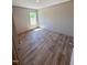 Bedroom with a window providing ample natural light and stylish wood-look flooring at 10 Riverview Rd, Erwin, NC 28339
