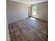 Cozy bedroom featuring a window, neutral wall colors, and wood-look flooring at 10 Riverview Rd, Erwin, NC 28339