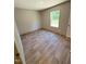 Comfortable bedroom with natural light from the window and wood-look flooring at 10 Riverview Rd, Erwin, NC 28339