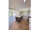 Well-lit kitchen and living area featuring an island with a sink and stainless steel appliances at 10 Riverview Rd, Erwin, NC 28339