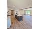 Spacious kitchen and living area featuring an island with a sink and stainless steel appliances at 10 Riverview Rd, Erwin, NC 28339