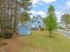Spacious backyard with a detached shed and a patio with a covered table at 101 Rustic Pine Ct, Apex, NC 27502