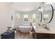Luxurious bathroom with a freestanding tub, double vanity, and modern fixtures, providing a spa-like experience at 101 Rustic Pine Ct, Apex, NC 27502