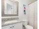 Well-lit bathroom featuring a granite countertop, framed mirror, and decorative shower curtain at 101 Rustic Pine Ct, Apex, NC 27502
