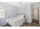 Cozy bedroom features a white metal bed frame, white ceiling fan, and light wood-look flooring at 101 Rustic Pine Ct, Apex, NC 27502