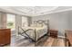 Cozy bedroom with tray ceilings, wood-look floors, and neutral tones, creating a serene retreat at 101 Rustic Pine Ct, Apex, NC 27502