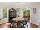 Bright dining area features a round table, black display cabinet, and sliding doors to the outdoor patio at 101 Rustic Pine Ct, Apex, NC 27502
