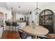Open dining area with a light wood table and stylish chairs, connected to the kitchen with bar seating at 101 Rustic Pine Ct, Apex, NC 27502
