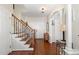 Warm and inviting foyer with hardwood floors and staircase with decorative iron railings at 101 Rustic Pine Ct, Apex, NC 27502