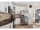 Updated kitchen featuring stainless steel appliances, white cabinets, granite counters, and tile backsplash at 101 Rustic Pine Ct, Apex, NC 27502