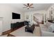 Cozy living room with hardwood floors, fireplace, media cabinet, and comfortable seating at 101 Rustic Pine Ct, Apex, NC 27502